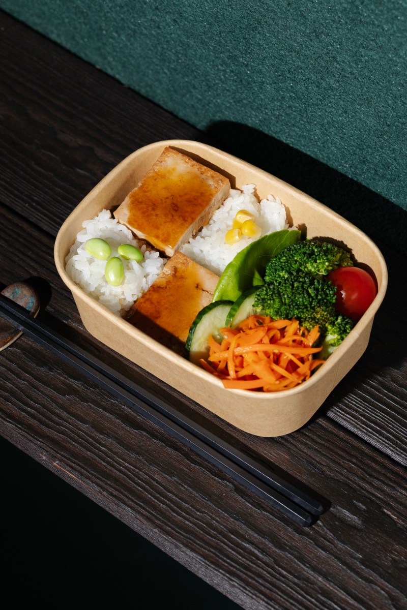 A Kawa Musubi Bento box (Japanese lunch box) on dark wood